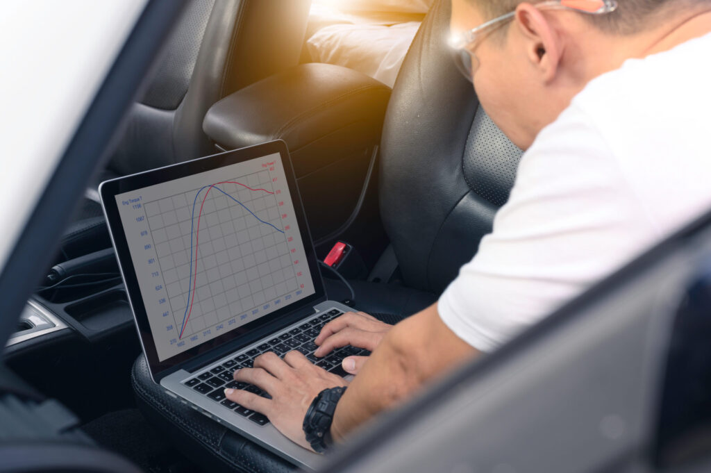 mechanic working on ECU tuning of vehicle