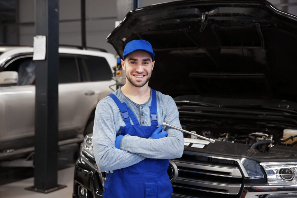 young mechanic working at ecu remapping service